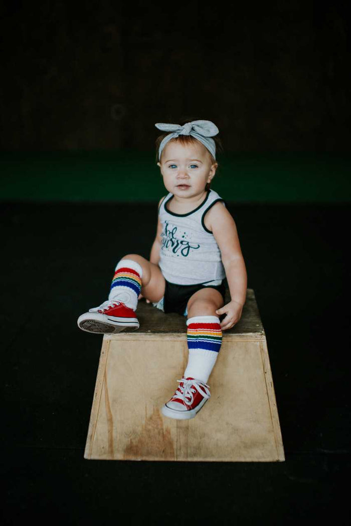Baby wearing colorful rainbow striped tube socks