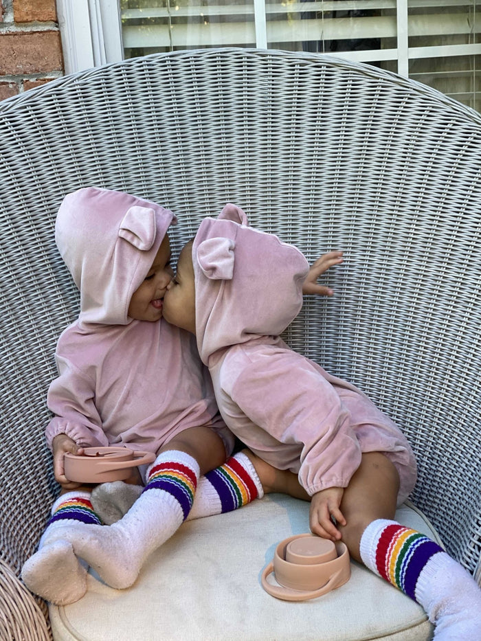 Toddler wearing Adventure rainbow tube socks indoors