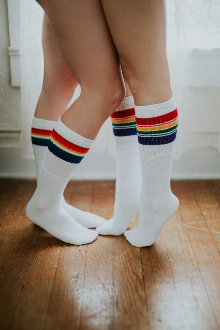 Person wearing Adventure rainbow socks during a dance with her wife