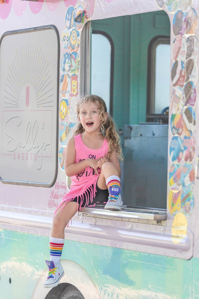 Colorful Fearless toddler tube socks styled with sneakers