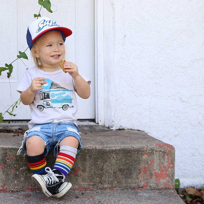 Lifestyle image of Happy rainbow baby and toddler socks while hanging out