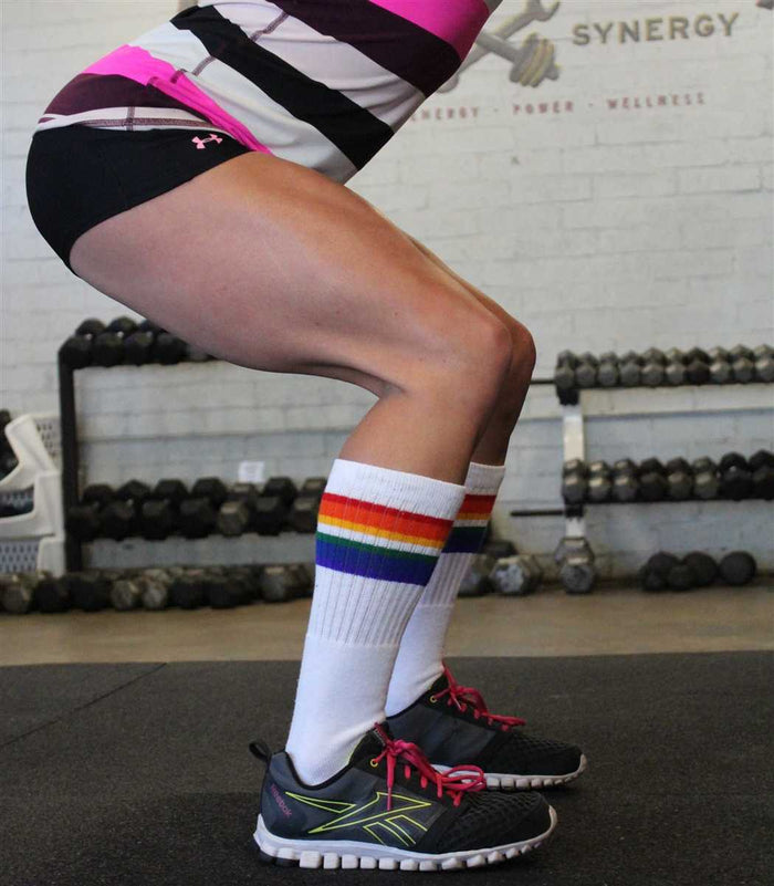Person wearing Love rainbow socks at outdoor event