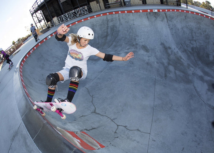 Strength rainbow socks styled with sneakers and casual outfit and skating in the bowl